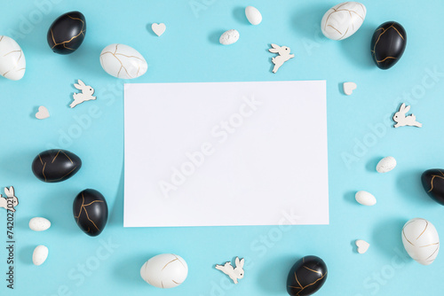 Easter holiday composition. Easter decorations, eggs, bunny rabbit on isolated pastel blue background. Easter concept. Flat lay, top view, copy space 