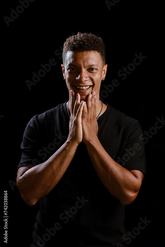 Obraz na płótnie Portrait of young African man smiling with black background w salonie