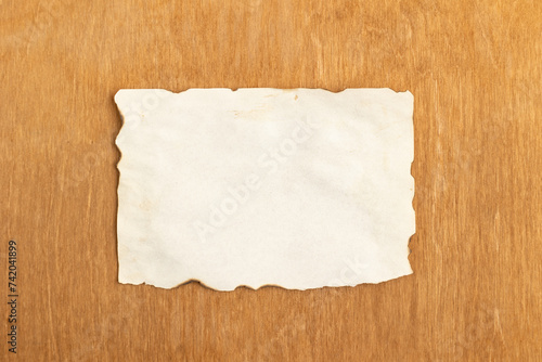Sheet of old vintage paper on a wooden background