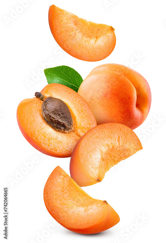 Apricot isolated. Apricot whole, half and slice are flying on white background. Apric with leaves. Falling fruit. Full depth of field. © Tim UR