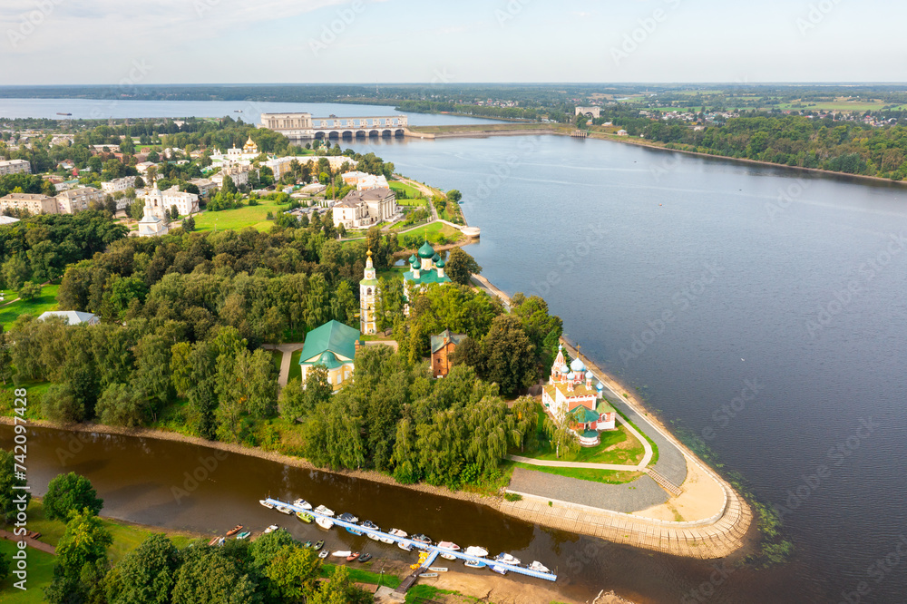 Drone view of the Volga River and temples, as well as residential areas in the city of Uglich in the summer afternoon, Russia