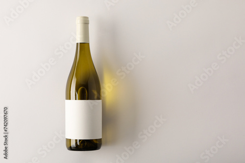 Obraz na plátně Bottle of tasty wine on white background, top view