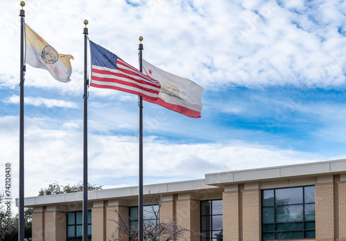Flying American Flag with California and San Leandro City Flag. photo