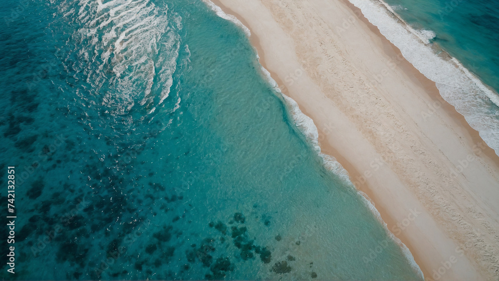 Aerial view of beach with white sand and blue water