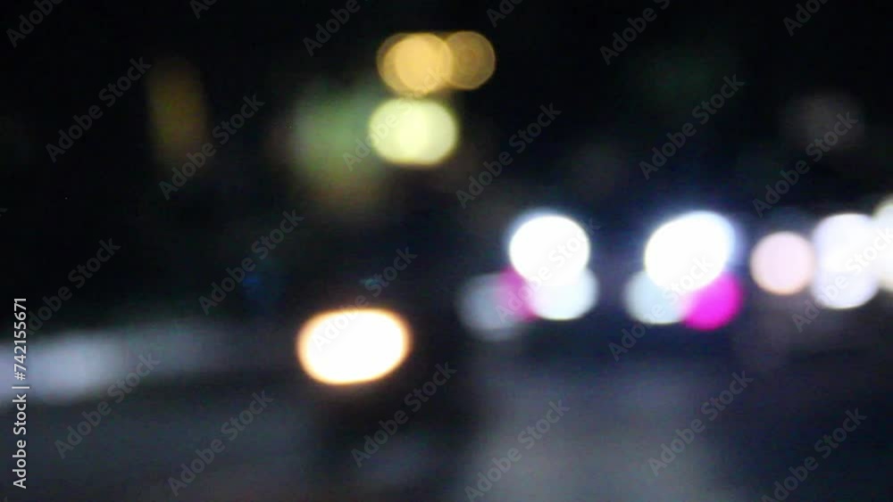 Traffic light in the night. Blur background car and motorbike lights. Blurred light in the street. Footage of traffic light. Traffic light in the night. Blur background car and motorbike lights. Blurred light in the street. Footage of traffic light.