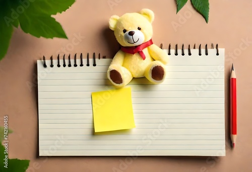teddy bear with steaky note, notebook and pencil photo