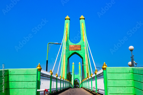 Green suspension bridge across Nan River at Chum Saeng District photo