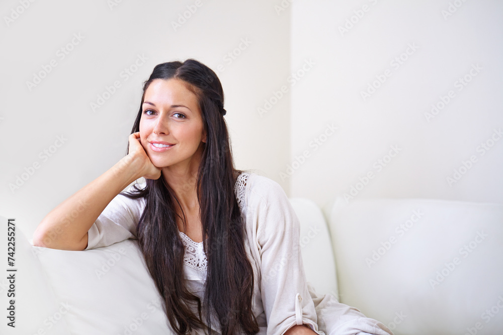 Portrait, smile and woman on sofa for wellness, relax and enjoyment on weekend. Calm, peaceful and face of young female person from California on couch in lounge, apartment or house in morning. Portrait, smile and woman on sofa for wellness, relax and enjoyment on weekend. Calm, peaceful and face of young female person from California on couch in lounge, apartment or house in morning.