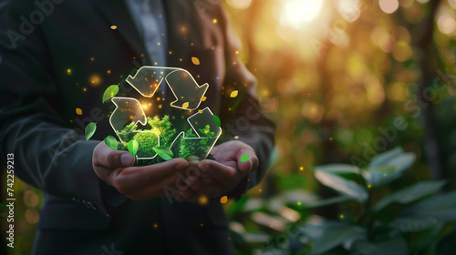 person holding a plant. Businessman holding circular economy icon. The concept of circular economy for future growth of business and environment sustainable and reducing pollution for future business photo
