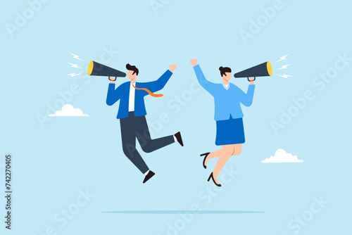 Businessman and businesswoman shouting by megaphone