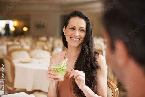 Happy woman  date and fine dining with drink for romance  love or bonding on anniversary at restaurant. Young woman smile with man on romantic dinner for good beverage  celebration or valentines day