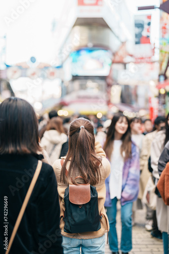 Tourist woman visit Ameyoko market, a busy market street located in Ueno. Landmark and popular for tourist attraction and Travel destination in Tokyo, Japan and Asia concept