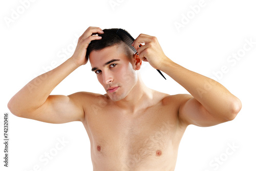 Portrait of handsome young man combing his hair on white background