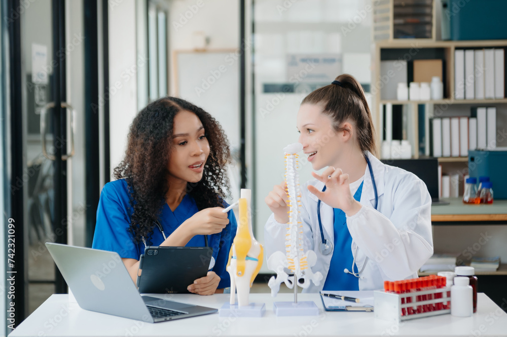 Doctor Talks With Professional Head Nurse or Surgeon, They Use Digital tablet Computer. Diverse Team of Health Care Specialists Discussing Test Result Doctor Talks With Professional Head Nurse or Surgeon, They Use Digital tablet Computer. Diverse Team of Health Care Specialists Discussing Test Result