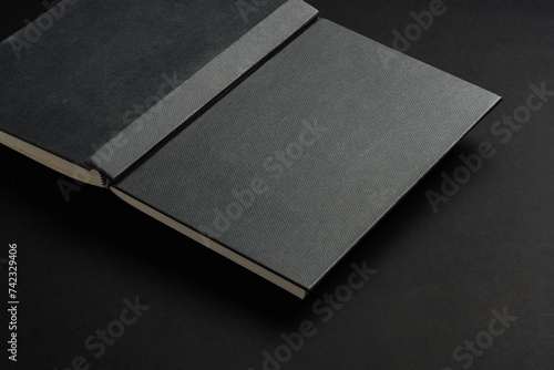 Bild auf Leinwand Black hardcover book or notepad mock up on black background