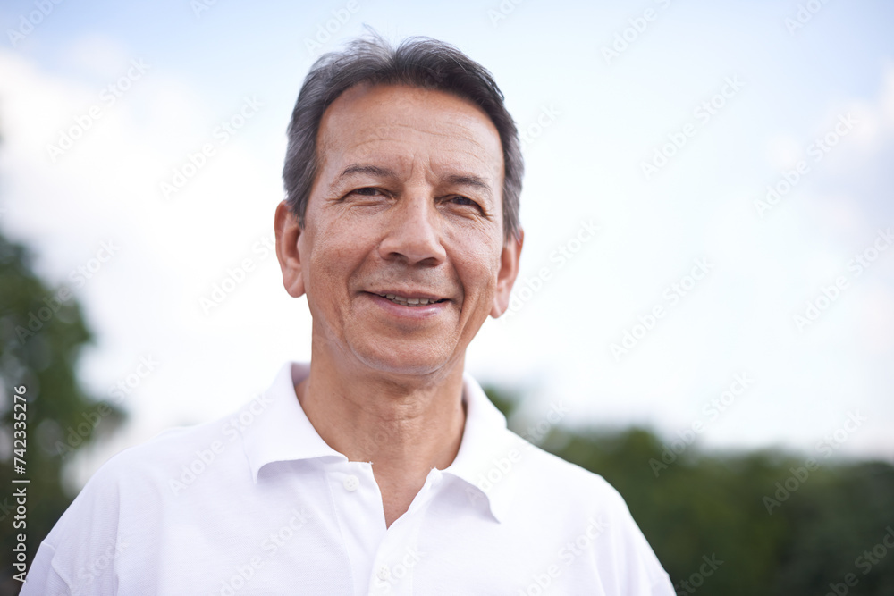Mature man, portrait and relax in outdoors, smile and cloudy sky in countryside or park. Male person, calm and fresh air for wellness on holiday or vacation, adventure and travel in nature for peace Mature man, portrait and relax in outdoors, smile and cloudy sky in countryside or park. Male person, calm and fresh air for wellness on holiday or vacation, adventure and travel in nature for peace