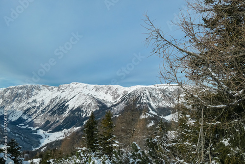 Panoramic view of snow capped mountain peak Hochschwab on the way to mount Hochanger, Muerzsteg Alps, Styria, Austria. Ski touring winter wonderland in remote Austrian Alps. Idyllic snowy forest photo