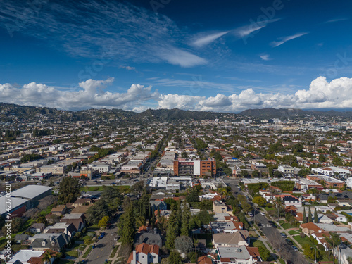 Aerial view of city of Los Angeles cityscape with beautiful clouds rolling over Hollywood Hills.