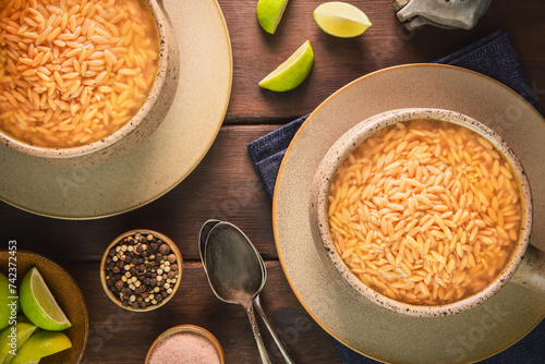 Arabic Cuisine; Traditional Middle Eastern orzo soup or bird tongue soup. It's delicious chicken broth with orzo pasta. Served with freshly ground black pepper and lemon.