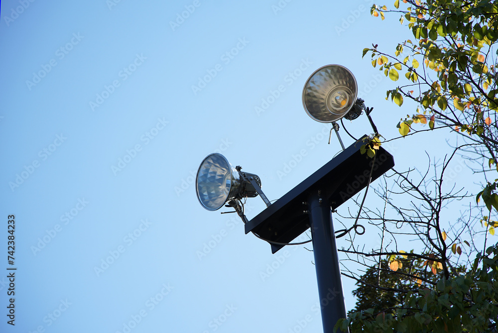 Lighting fixtures in the square against the background of the blue sky on a sunny day Lighting fixtures in the square against the background of the blue sky on a sunny day
