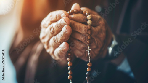 Closeup of monk's hands holding a rosary