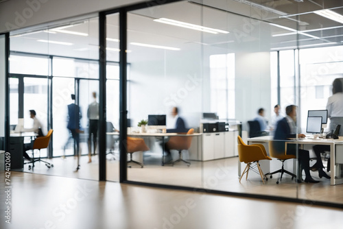 Blurred office with people working behind glass wall  © Giuseppe Cammino