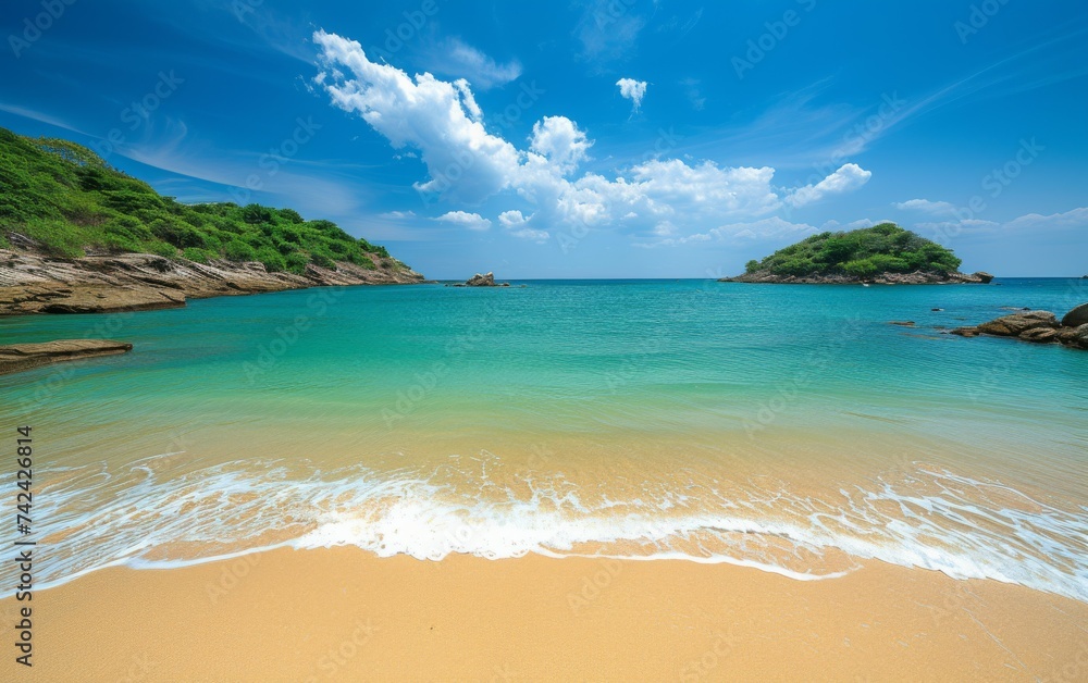 Fototapeta premium A sandy beach with waves breaking on the shore, creating white foam as they move towards land