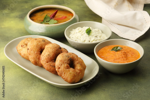 Vada / Medu vadai with sambar - Popular South Indian snack served on a steel serving plate, selective focus