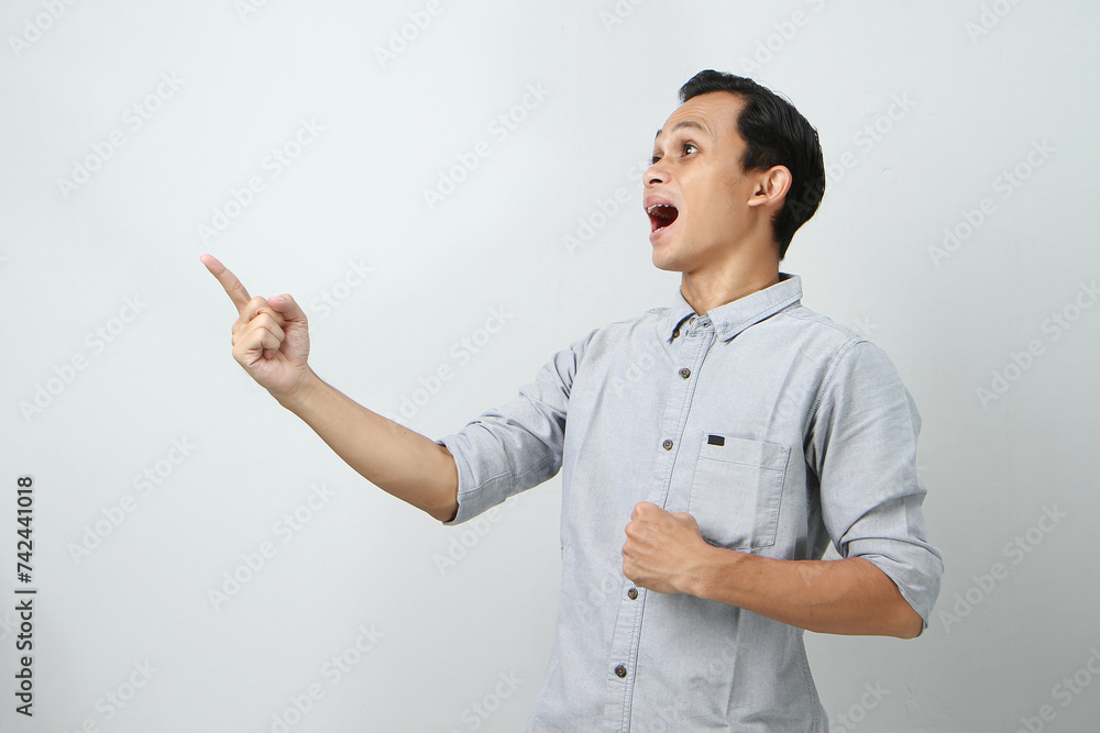 cheerful happy confident asian indonesian man with pointing finger gesture on isolated background cheerful happy confident asian indonesian man with pointing finger gesture on isolated background