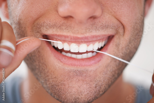 Dental  floss and closeup of man with teeth whitening  fresh breathe and cavity prevention for health and hygiene. Oral care  string or thread for orthodontics with veneers and mouth cleaning