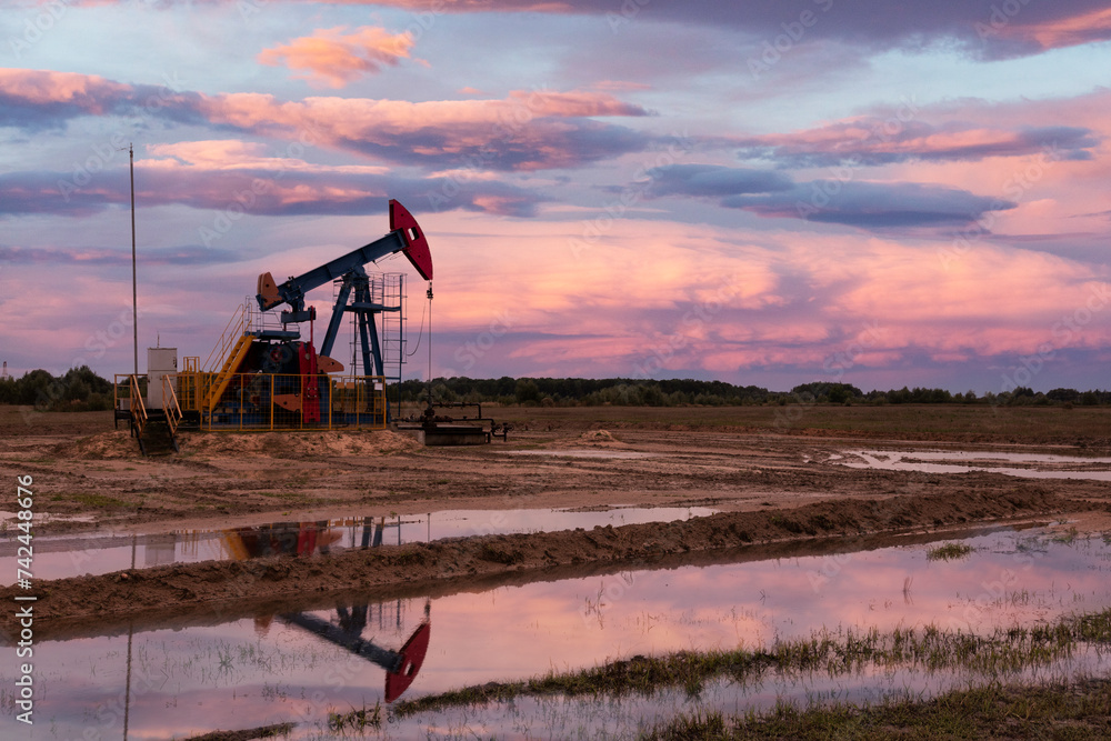 Fototapeta premium Oil industry. Oil rigs. oil pumps at sunset. Copy space.