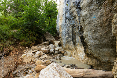 Dirty mountain river after rain, among wild rocks.