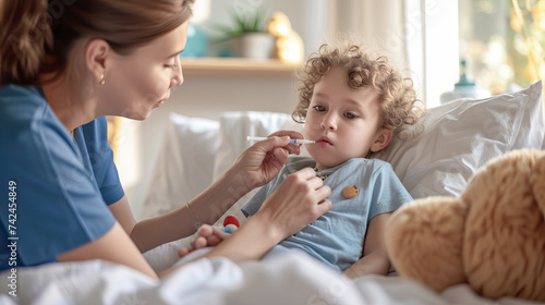 A mother sits at the bedside of a sick child and treats him
