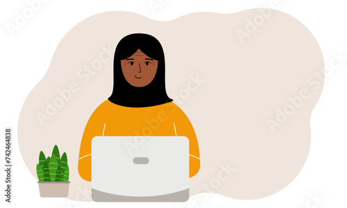 A woman is working or studying at a laptop. Freelancing or distance learning and work concept.