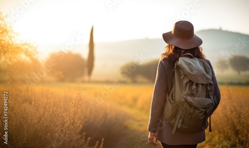 Tuscan Serenity: Against the Backdrop of a Tuscan Sunset, a Woman Tourist Walking at the Lush Fields, Captivated by Tuscany's Timeless Splendor.   © Mr. Bolota