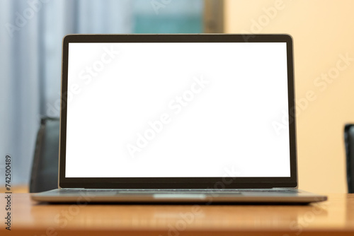 Laptop computer with white blank screen on wood desk. Workspace, workplace, desktop office concept.