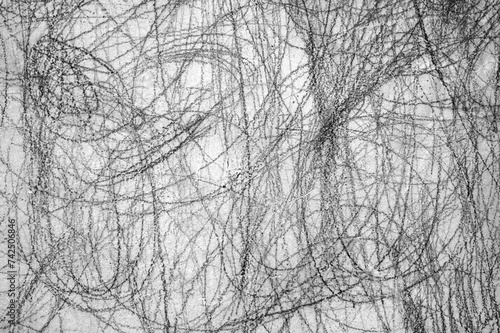 Abstract scribble, scrawl by pencil on the gray wall as texture or background