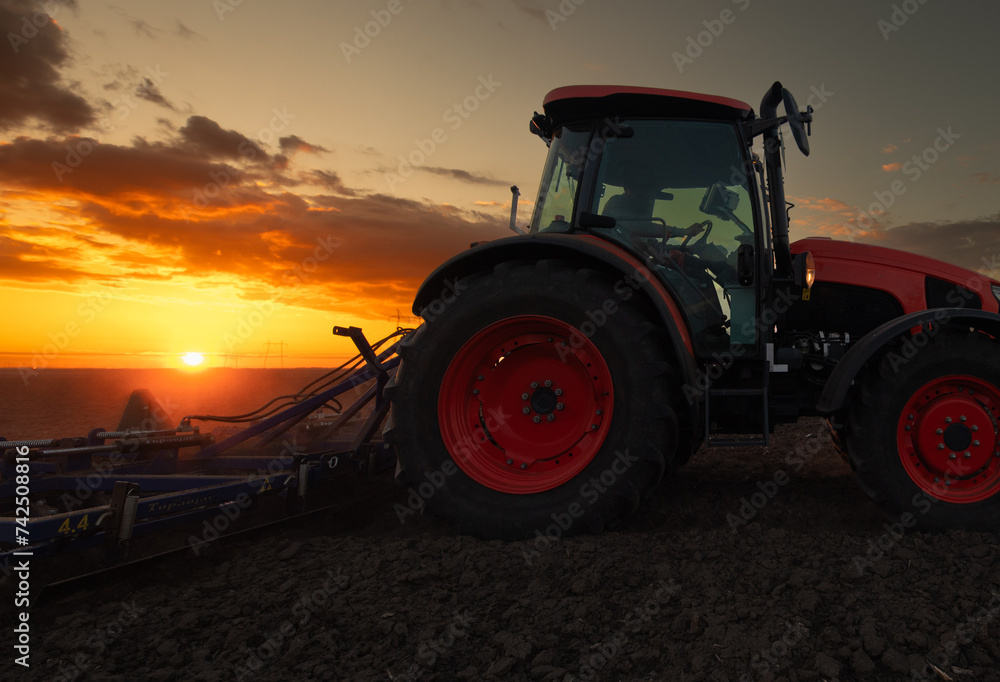 Tractor preparing the land for a new crop planting Tractor preparing the land for a new crop planting