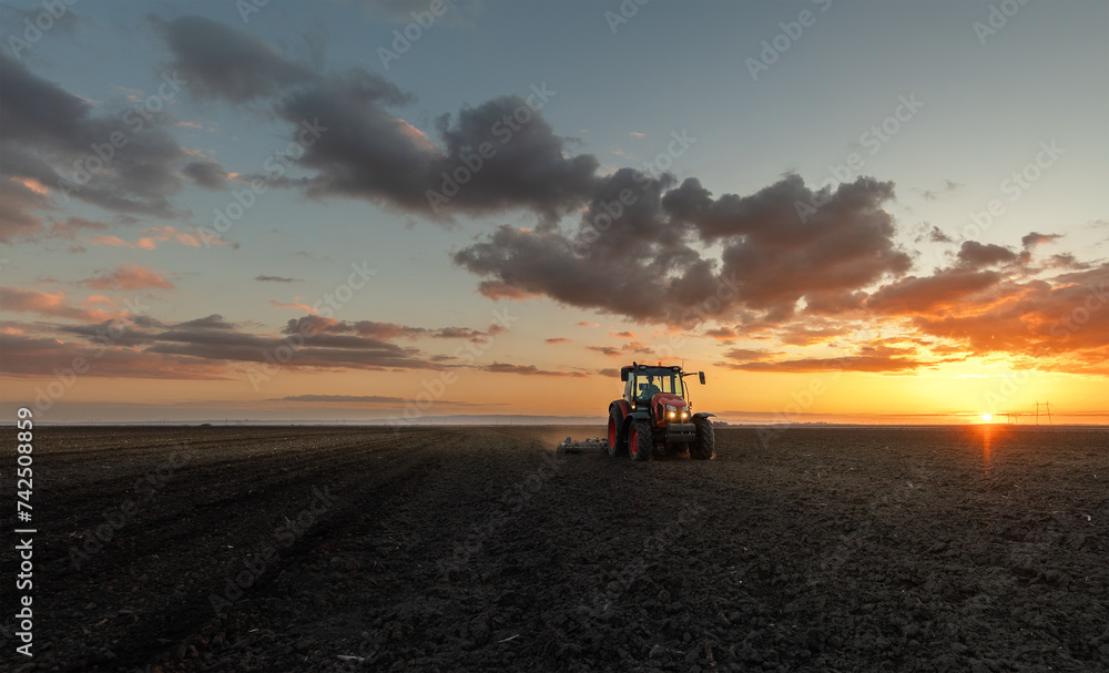 Tractor preparing the land for a new crop planting Tractor preparing the land for a new crop planting