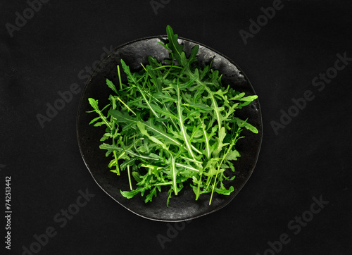 Arugula on Black Plate  Fresh Arugula  Ruccola Leaves  Rucola  Eruca or Garden Roquette Salad