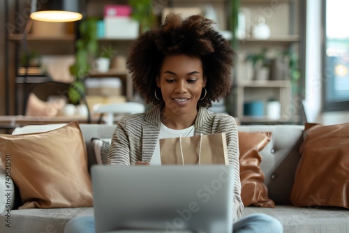 A Young Africanamerican Woman on Couch Using Laptop in the Style of Code-based Creations