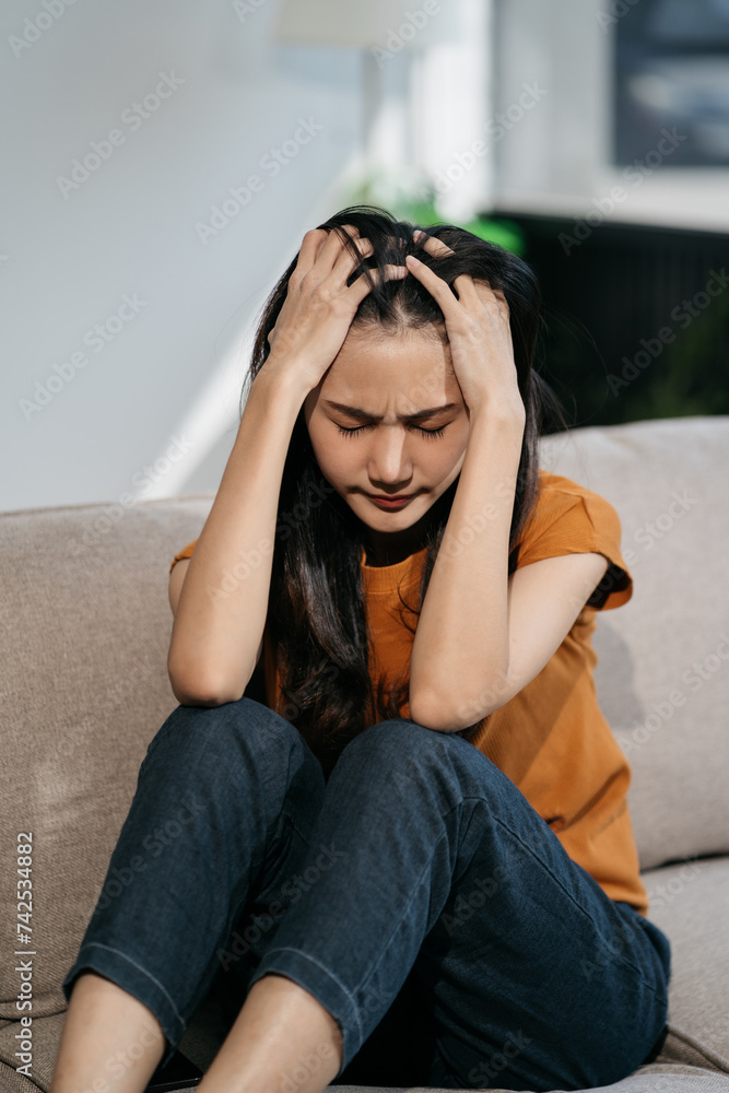 Sad and depressed young female sitting on the sofa, sad mood, feel tired, lonely and unhappy concept. Sad and depressed young female sitting on the sofa, sad mood, feel tired, lonely and unhappy concept.