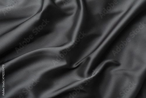Texture of black crumpled silk fabric as background, closeup
