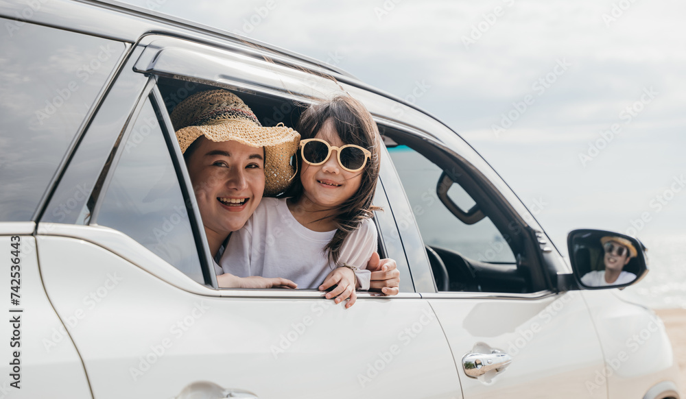 Car insurance. Father, mother and children girl smiling having fun sitting in compact white car look out window blue sky, Summer at beach, Family holiday vacation travel, car travel, Happy family day