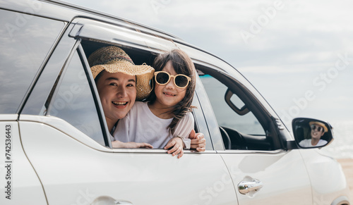 Car insurance. Father, mother and children girl smiling having fun sitting in compact white car look out window blue sky, Summer at beach, Family holiday vacation travel, car travel, Happy family day