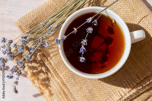 Lavender flowers with herbal cup of tea. Concept of Herbal medicine natural remedy. Organic relieving stress. Healthy beverage fresh delicious floral hot tea. Antispasmodic effect naturopathy concept photo