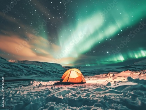 A snow covered landscape with a campsite beneath the northern lights