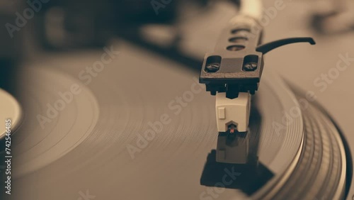 DJ Headshell on Spinning Turntable Listening the Music on Vinyl photo