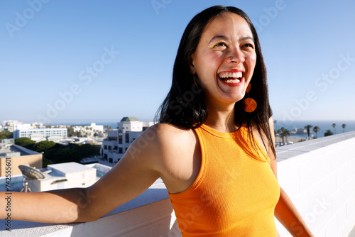 Candid Photo of An Attractive Smiling South American Woman in the Rooftop in the Morning, Los Angeles