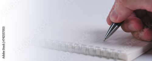 Ink Trails Capturing Thoughts with Pen and Notebook, a man hand using pen writing on paper notebook page